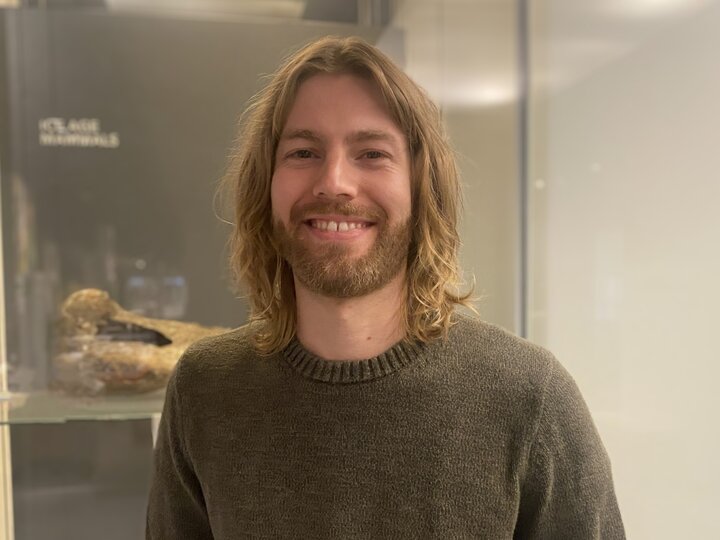 Image of Jeremy in front of a fossil