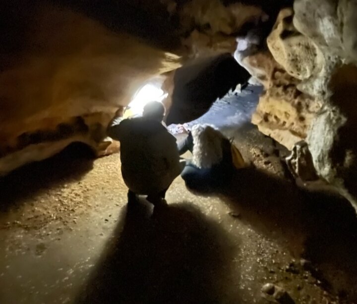 Kate Lyons examining cave art in Bernifal Cave, France